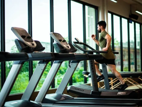 Man running on a treadmill in a gym